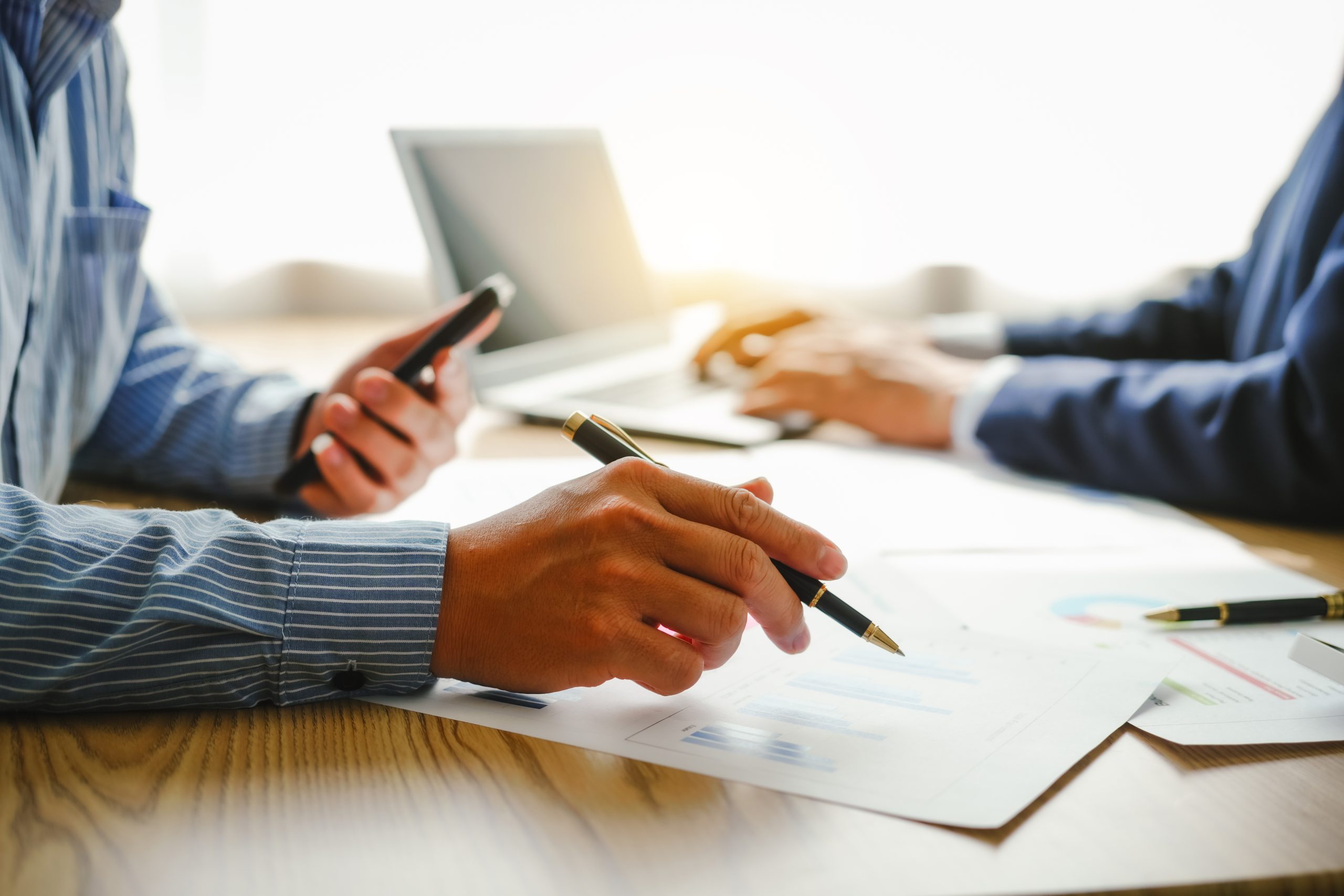 close up image of hands with pen and calculator
